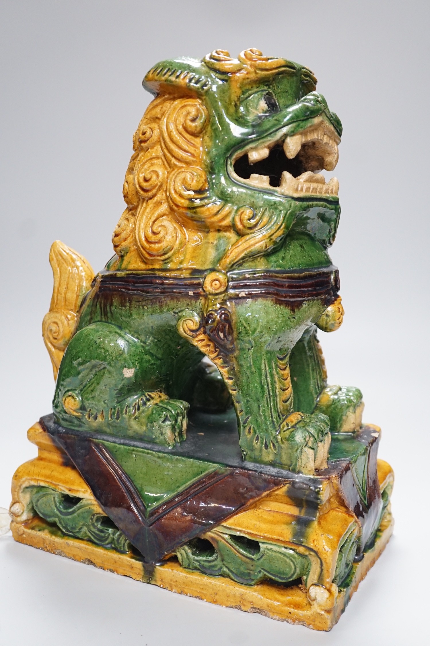 A large Chinese sancai glazed lion dog, 38cms high